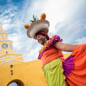 Happy Palenquera selling fruits in Cartagena - travel like a local concept